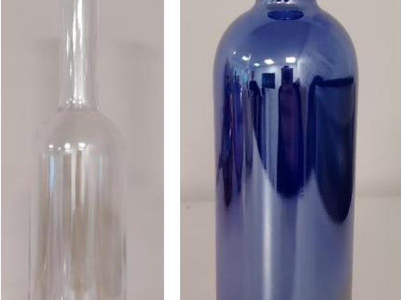A clear bottle and a blue mirror-coated bottle
