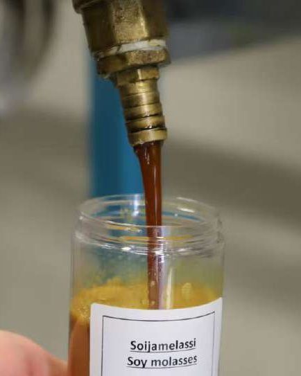 A refined side stream poured into a sample jar