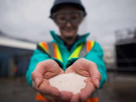 Hands holding white bioplastic powder