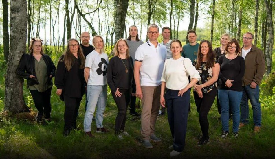 The Brightplus team standing in a birch forest